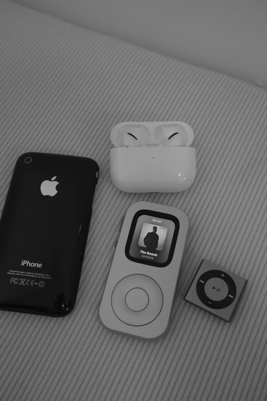 RePod C1 shown from the front beside AirPods and two earlier iPhones