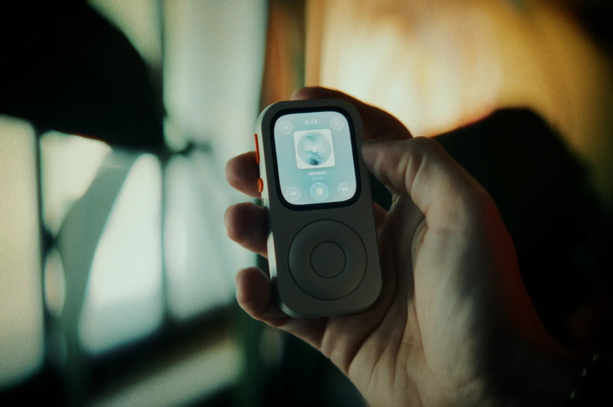 A front-facing RePod held in one hand with music playback visible on Apple Watch