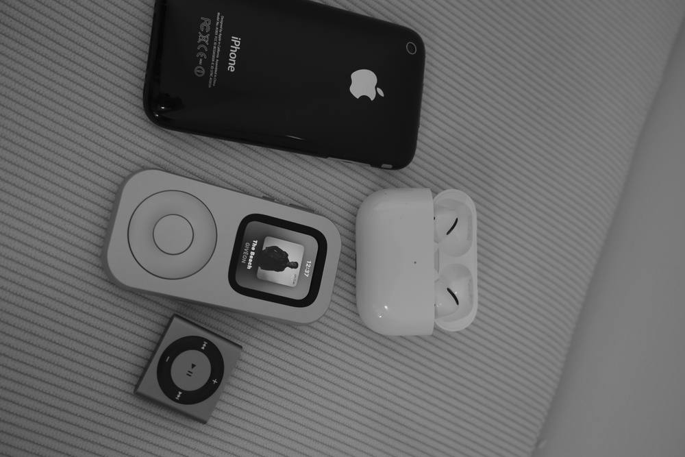 RePod, an iPhone, AirPods and a compact music player arranged in a flat lay.
