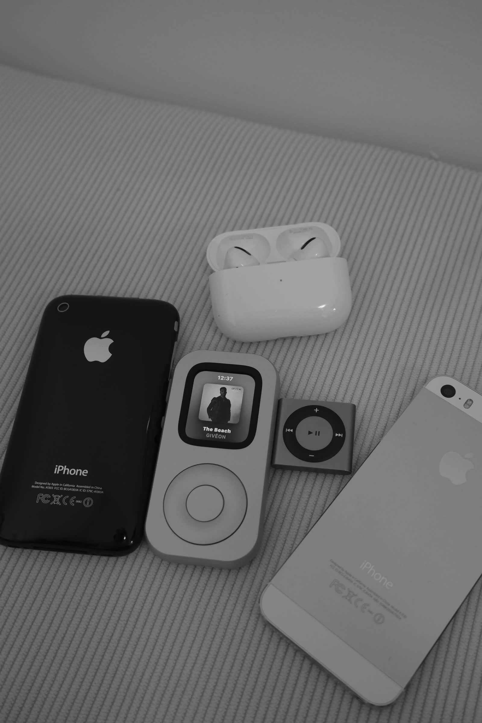 Front-facing RePod arranged with earlier Apple devices in a carefully styled flat lay