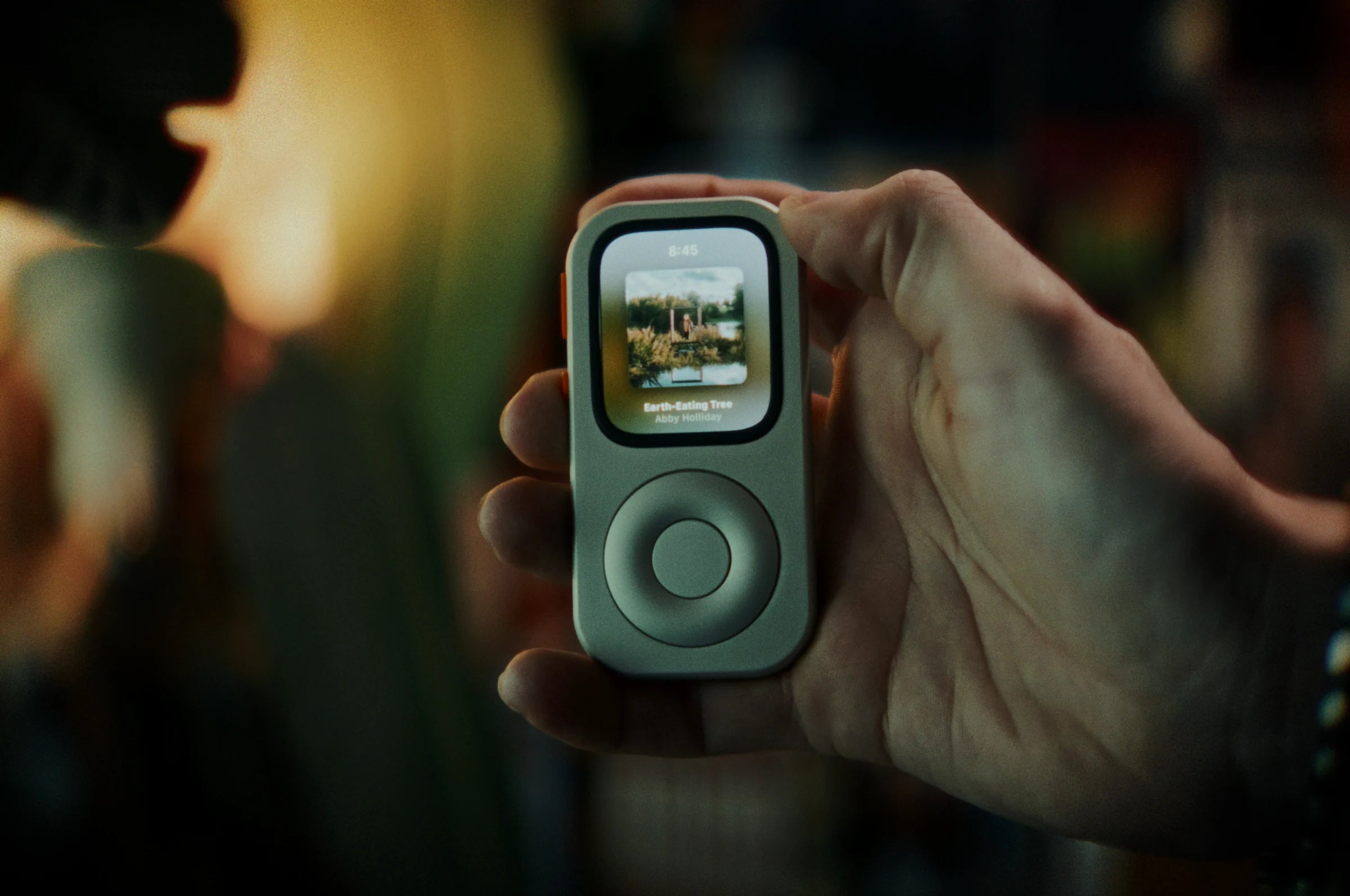 RePod held in one hand with album artwork visible on Apple Watch