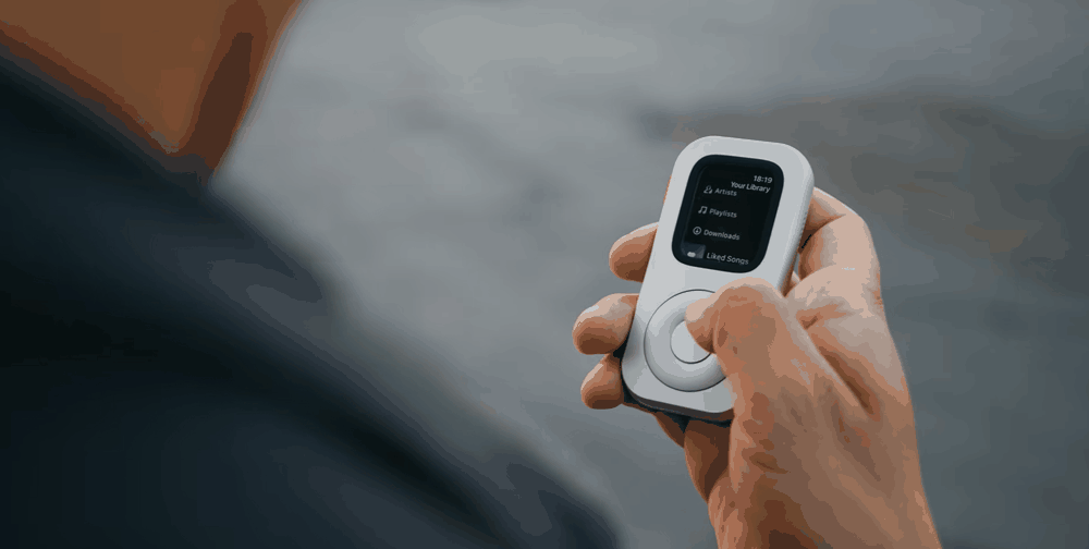 Front view of RePod held outdoors with an Apple Watch music library on screen